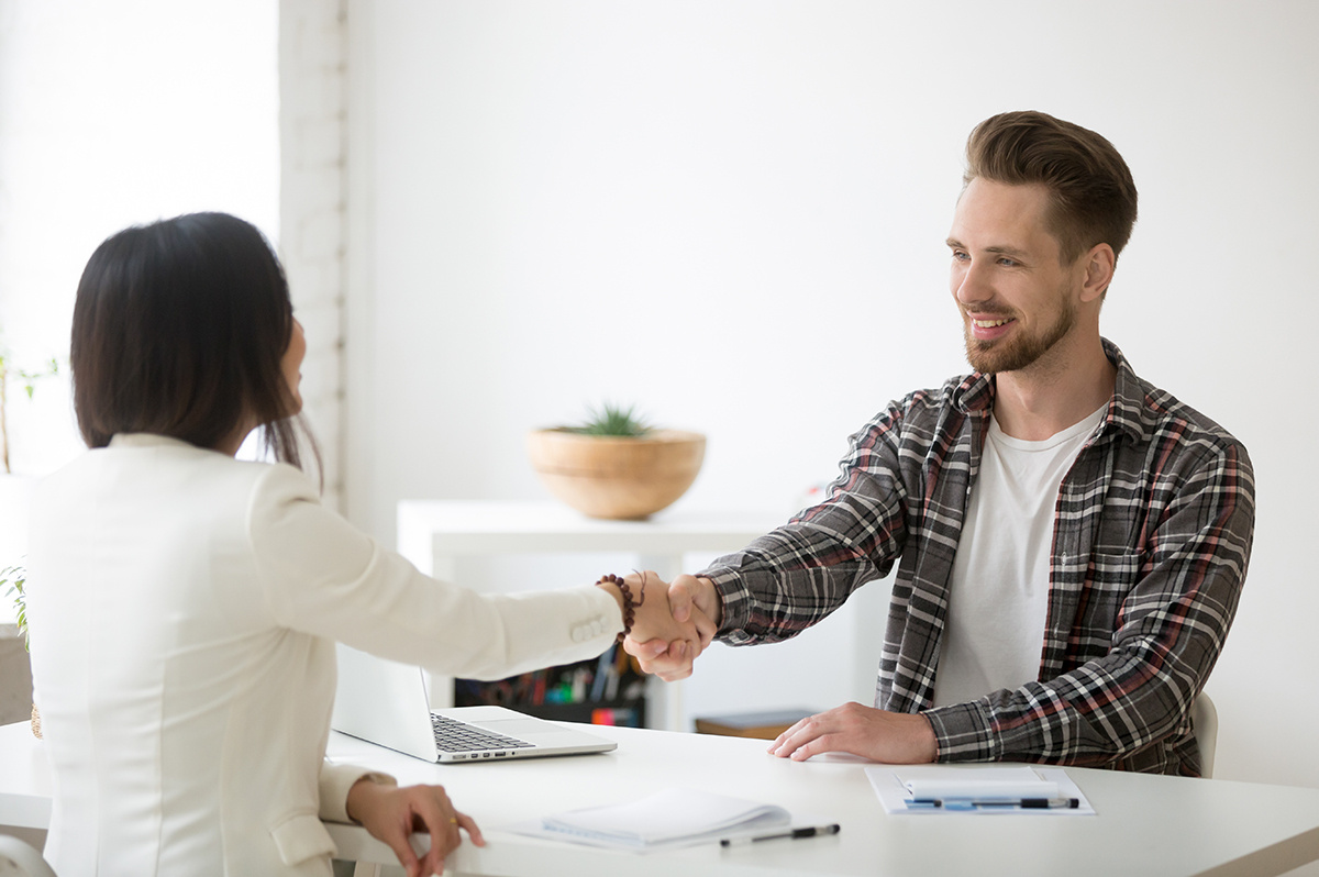 smiling-millennial-partners-handshaking-office-thanking-successful-teamwork-1